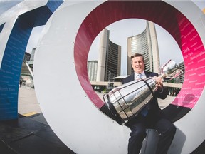 Toronto mayor and former CFL commissioner John Tory poses with the Grey Cup in front of Toronto city hall. For column by Edmonton columnist Terry Jones. (Photo courtesy Johany Jutras)