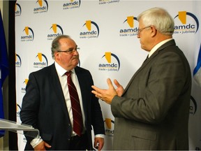 Alberta Infrastructure Minister Brian Mason (left) and Al Kemmere, president of the Alberta Association of Municipal Districts and Counties, discuss funding Tuesday for bridges, roads and airports.