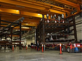 A Saipem Canada engineer stands beside a module under construction inside the Italian firm's northeast Edmonton facility in this 2013 file photo.