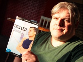 Steven Sandor with a copy of his latest young adult novel, Trolled.