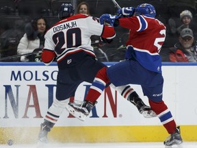 Edmonton Oil Kings forward Tyler Robertson battles Lethbridge Hurricanes forward Shaun Dosanjh at Rogers Place in Edmonton on Monday, December 5, 2016.