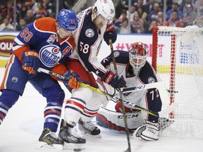 Columbus Blue Jackets goalie Sergei Bobrovsky makes the save as Edmonton Oilers forward Ryan Nugent-Hopkins (93) and David Savard (58) battle for the rebound during second period at Rogers Place on Tuesday December 13, 2016.