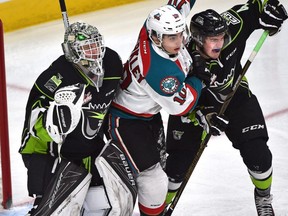 Edmonton Oil Kings goalie Patrick Dea and defenceman Will Warm sandwich Kelowna Rockets forward Nick Merkley at Rogers Place on Monday, December 18, 2016. (Ed Kaiser)