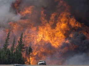 A giant fireball is seen as a wild fire rips through the forest 16 km south of Fort McMurray on Highway 63 on Saturday, May 7, 2016.