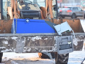 A man is in custody after a front end loader was used to crash through a north Edmonton CashCo storefront and steal an ATM.