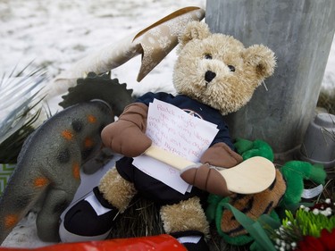 A memorial is seen outside a home where three bodies were found on Monday in Spruce Grove, Alta., on Tuesday, Dec. 20, 2016.