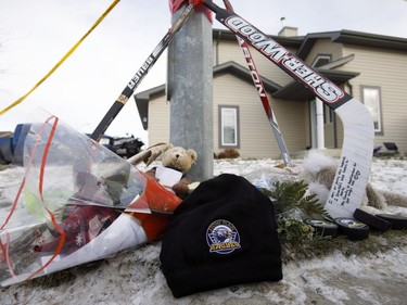 A memorial is seen outside a home where three bodies were found on Monday in Spruce Grove, Alta., on Tuesday, Dec. 20, 2016.