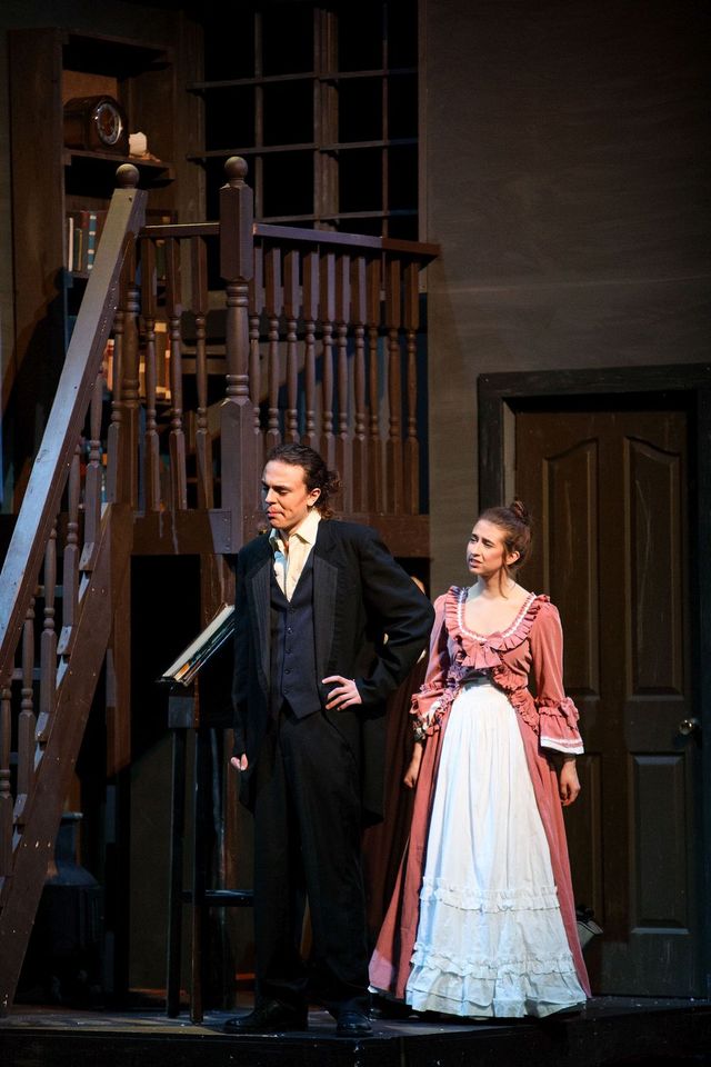 A younger Ebenezer Scrooge (Ayden Limon Falcon), left, speaks with a former fiance, Belle (Anna Van Woerkom) during Archbishop Jordan Catholic High School's production of A Christmas Carol.