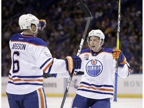 Edmonton Oilers' Tyler Pitlick, right, is congratulated by Adam Larsson, of Sweden, after scoring during the first period of an NHL hockey game against the St. Louis Blues Monday, Dec. 19, 2016, in St. Louis.