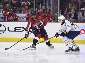 Washington Capitals left wing Alex Ovechkin (8), of Russia, handles the puck in front of Buffalo Sabres defenseman Brendan Guhle (45) during second period of an NHL hockey game, Monday, Dec. 5, 2016, in Washington. Washington beat Buffalo 3-2 in overtime.