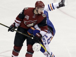 Arizona Coyotes defenseman Connor Murphy (5) checks Edmonton Oilers centre Connor McDavid during the third period of an NHL hockey game, Wednesday, Dec. 21, 2016, in Glendale, Ariz.