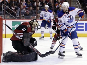Arizona Coyotes goalie Mike Smith makes the save in front of Edmonton Oilers centre Mark Letestu during NHL action on Dec. 21, 2016, in Glendale, Ariz.