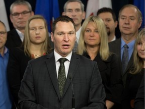 Economic Development Minister Deron Bilous, along with representatives of 18 businesses and groups, speak on the results of a November trade mission to China and Japan at the Alberta legislature, in Edmonton on Friday Dec. 9, 2016.