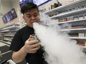 Ben Joy Dola demonstrates how CBD (cannabidiol) additives are vaped at Digital Imports in Edmonton on Wednesday, Dec. 21, 2016.