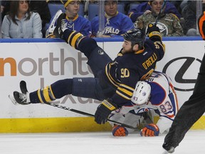 Buffalo Sabres Ryan O'Reilly (90) is upended by Edmonton Oilers Matthew Benning (83) during the first period of an NHL hockey game, Tuesday, Dec. 6, 2016, in Buffalo, N.Y.