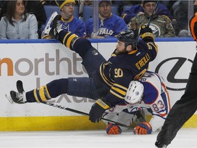 Buffalo Sabres Ryan O'Reilly (90) is upended by Edmonton Oilers Matthew Benning (83) during the first period of an NHL hockey game, Tuesday, Dec. 6, 2016, in Buffalo, N.Y.