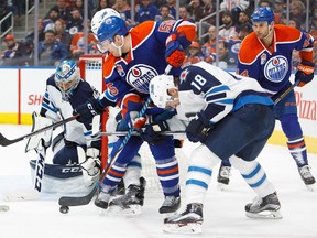 Mark Letestu #55 of the Edmonton Oilers looks for a shot on goalie Connor Hellebuyck #37 of the Winnipeg Jets on December 11, 2016 at Rogers Place.