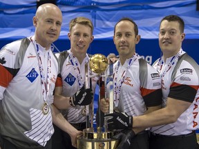 Canada's skip Kevin Koe, third Marc Kennedy, second Brent Laing, lead Ben Hebert, from left, celebrate with the trophy after winning the gold medal game against Denmark at the world men's curling championship 2016 in the St. Jakobshalle in Basel, Switzerland, on Sunday April 10, 2016. (Georgios Kefalas/Keystone via AP) ORG XMIT: LON842