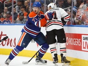 Oscar Klefbom #77 of the Edmonton Oilers defends against Andrew Desjardins #11 of the Chicago Blackhawks on November 21, 2016 at Rogers Place in Edmonton, Alberta, Canada.