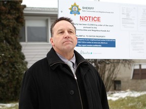 Chip Sawchuk, manager of the Alberta Sheriffs Northern Alberta Safer Communities and Neighbourhoods unit, stands outside a property at 9103 137 Ave. in Edmonton on Dec. 1, 2016, that was shuttered for 90 days after complaints of suspected drug activity and prostitution.