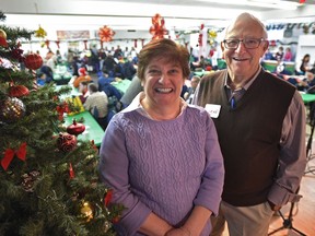 Lorne Hooper has been volunteering at the midday Boyle Street Christmas Dinner for decades, while Sunday was Linda Hajjar's first time.