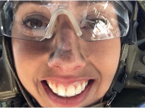 Claire Theobald shows off a full face of dirt after riding along in the gunner seat of a Light Armoured Vehicle 6 on April 21, 2016, during Operation Promethean Ram at CFB Wainwright, a month-long live fire exercise that serves as one of the final tests of readiness for Canadian troops who will be deployed in combat.