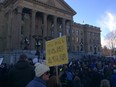 A crowd protesting the NDP government's carbon tax gathers in front of the Alberta legislature Saturday afternoon. The event was organized by the Rebel Media.