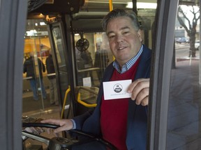 Coun. Dave Loken holds a Donate A Ride pledge card on an ETS bus on Dec. 19,  2016. The program provides Edmonton Transit System (ETS) tickets to Edmontonians in need.