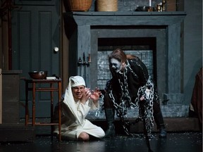 Ebenezer Scrooge (Jonah Ross) is confronted by the ghost of Jacob Marley (Kennedy MacGregor) during Archbishop Jordan Catholic High School's production of A Christmas Carol.