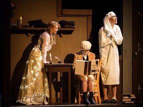 Ebenezer Scrooge (Jonah Ross), right, meets his young self (Abby St. John), centre, while being visited by the Ghost of Christmas Past (Elana Svenningsen) during Archbishop Jordan Catholic High School's production of A Christmas Carol.