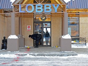 Police collect evidence at a fatal stabbing at the Travelodge on Calgary Trail in 2013.