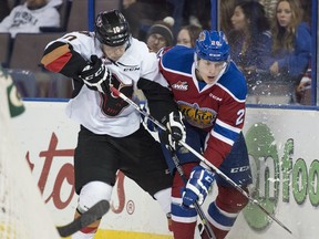 EDMONTON, AB. NOVEMBER 7,  2015 - Anatolli Elizarov of the Edmonton Oil Kings, is hit by Jakob Stukel of the Calgary HItmen at Rexall Place in Edmonton. Shaughn Butts / Edmonton Journal ******EDMONTON SUN OUT**********