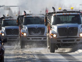 Trucks plow and sand along Castle Downs Road in Edmonton in a 2012 file photo.