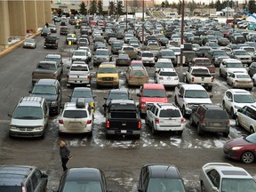 A parking lot packed with cars just before Christmas.