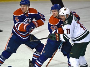 EDMONTON, ALTA: FEBRUARY 18, 2016 -- Edmonton Oilers Mark Letestu (55) ties up Minnesota Wild Zach Parise (11) as the puck flies past Mark Fayne (5) during NHL action at Rexall Place in Edmonton, February 18, 2016. (ED KAISER/PHOTOGRAPHER)