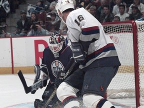 Vancouver Canucks forward Trevor Linden tests Edmonton Oilers goalie Bob Essensa during NHL action at GM Place in Vancouver on Oct. 13, 1997.