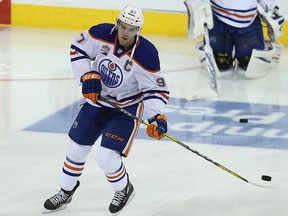 Edmonton Oilers captain Connor McDavid juggles a puck on his stick during warmup prior to NHL action against the Winnipeg Jets in Winnipeg on Thu., Dec. 1, 2016.