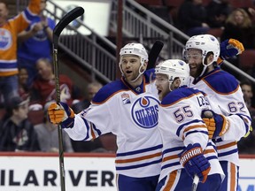 Edmonton Oilers center Mark Letestu (55) celebrates with Zack Kassian and Eric Gryba (62) after scoring a goal against the Arizona Coyotes in the first period during an NHL hockey game, Wednesday, Dec. 21, 2016, in Glendale, Ariz.
