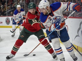 Edmonton Oilers center Mark Letestu, right, passes the puck through the legs of Minnesota Wild defenceman Nate Prosser on Friday, Dec. 9, 2016, in St. Paul, Minn. (AP Photo)