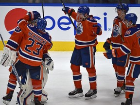 Edmonton Oilers players congratulate goalie Cam Talbot after a shoot-out win over the Tampa Bay Lightning at Rogers Place on Dec. 17, 2016.