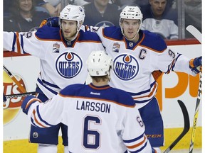 Edmonton Oilers Leon Draisaitl (29), Adam Larsson (6) and Connor McDavid (97) celebrate Draisaitl's goal against the Winnipeg Jets during third period NHL action in Winnipeg on Thursday, December 1, 2016.