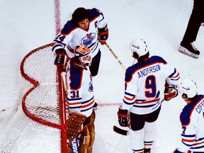 Edmonton Oilers goalie Eddie Mio stands with teammates Blair McDonald, top, Glen Anderson, middle, and Paul Coffey during NHL action in 1980.