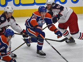 Edmonton Oilers Leon Draisaitl (29) splits between Columbus Blue Jackets William Karlsson (25) and David Savard (58) during the first period of NHL action at Rogers Place in Edmonton, Wednesday, December 13, 2016. Ed Kaiser/Postmedia (Edmonton Journal story by Jim Matheson) Photos off Oilers game for multiple writers copy in Dec. 14 editions.
