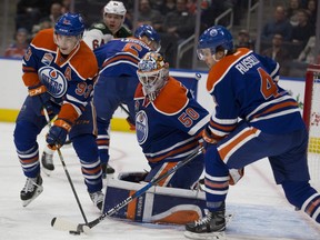 Edmonton Oilers  Ryan Nugent-Hopkins (93) clears the puck from in front of goalie Jonas Gustavsson (50) and Kris Russell (4) during first period NHL action against the Minnesota Wild  on Sunday, December 4, 2016  in Edmonton.   Greg  Southam / Postmedia  (To go with a sports story.) Photos off Oilers game for multiple writers copy in Dec. 5 editions.