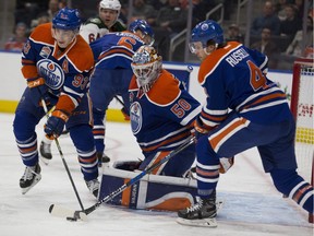 Edmonton Oilers  Ryan Nugent-Hopkins (93) clears the puck from in front of goalie Jonas Gustavsson (50) and Kris Russell (4) during first period NHL action against the Minnesota Wild  on Sunday, December 4, 2016  in Edmonton.   Greg  Southam / Postmedia  (To go with a sports story.) Photos off Oilers game for multiple writers copy in Dec. 5 editions.