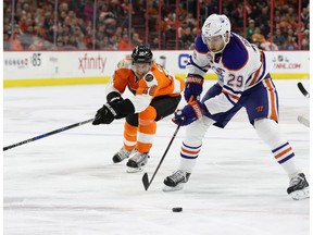 Leon Draisaitl, right, of the Edmonton Oilers moves the puck in front of Brayden Schenn of the Philadelphia Flyers before scoring a first period goal at Wells Fargo Center on December 8, 2016 in Philadelphia, Pennsylvania.