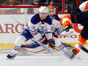 Brandon Davidson #88 and Cam Talbot #33 of the Edmonton Oilers protect the net against Ryan White #25 of the Philadelphia Flyers during the first period at the Wells Fargo Center on March 3, 2016 in Philadelphia, Pennsylvania.