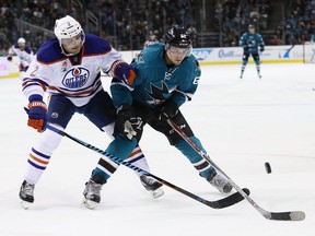 SAN JOSE, CA - DECEMBER 23:  Andrej Sekera #2 of the Edmonton Oilers and Kevin Labanc #62 of the San Jose Sharks go for the puck at SAP Center on December 23, 2016 in San Jose, California.