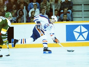 Edmonton Oilers centre Wayne Gretzky takes a shot during NHL action at Northlands Coliseum against the visiting Minnesota North Stars on Dec. 6, 1987.