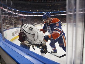 Edmonton's Adam Larsson (6) battles LA's Kyle Clifford (13) during the first period of a NHL game at Rogers Place in Edmonton, Alberta on Thursday, December 29, 2016. Ian Kucerak / Postmedia